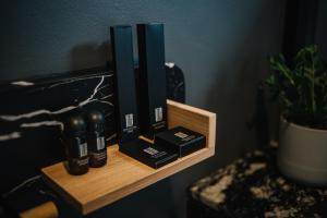 a wooden shelf with a group of bottles on it at INN BLOG HOTEL Pakbara in Satun