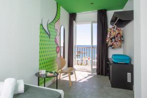 a bedroom with a bed and a room with a balcony at Casual Pop Art Benidorm in Benidorm