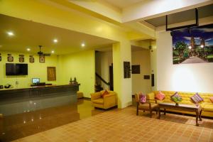 a lobby with two couches and a flat screen tv at Melody Boutique Hotel in Siem Reap