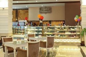 a bakery with two tables and a counter with pastries at Crystal Waterworld Resort & Spa - Ultimate All Inclusive in Belek