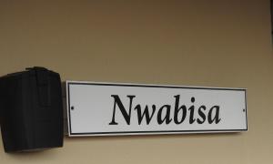 a sign on a wall with the word nega at Marina Sands 13A in Jeffreys Bay