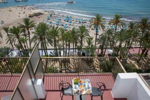 a table with food on a balcony overlooking a beach at Casual Pop Art Benidorm in Benidorm