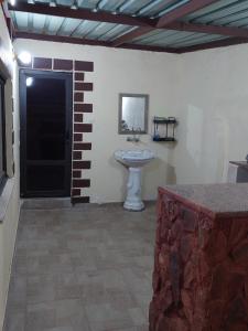 a bathroom with a sink in a room at Wadi Rum Oryx Hostel & Tours in Wadi Rum
