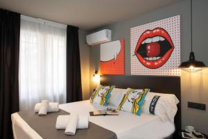a bedroom with a bed with a mouth on the wall at Casual Pop Art Benidorm in Benidorm