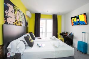 a bedroom with two beds and a desk in it at Casual Pop Art Benidorm in Benidorm