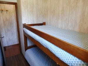 a bunk bed in a small room with a door at Appartement Crest-Voland, 1 pièce, 4 personnes - FR-1-595-64 in Crest-Voland