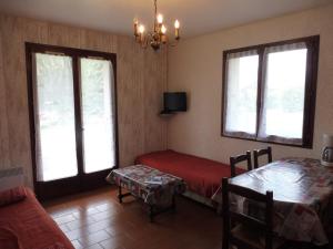 a room with a bed and a table and windows at Appartement Crest-Voland, 1 pièce, 4 personnes - FR-1-595-64 in Crest-Voland