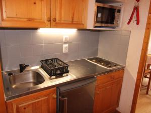 a kitchen counter with a sink and a stove at Appartement Les Saisies, 2 pièces, 5 personnes - FR-1-594-81 in Hauteluce