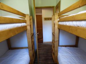 two bunk beds in a room with a hallway at Appartement Les Saisies, 3 pièces, 8 personnes - FR-1-594-71 in Hauteluce