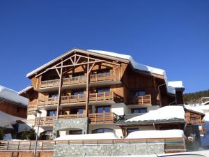 a large wooden building with snow on it at Appartement Les Saisies, 3 pièces, 8 personnes - FR-1-594-71 in Hauteluce