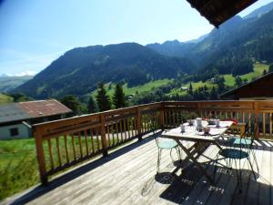 a table on a deck with a view of mountains at Chalet Hauteluce, 3 pièces, 8 personnes - FR-1-594-63 in Hauteluce