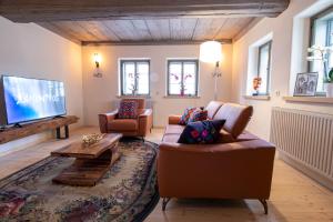 a living room with two couches and a flat screen tv at außergewöhnliches, historisches, spätgotisches Wohnhaus von 1519, Gries 5 in Gera