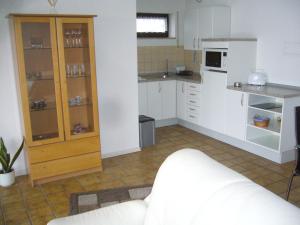 a kitchen with white cabinets and a white counter at Ferienwohnung Erika in Grenzach-Wyhlen