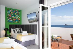 a bedroom with a bed and a view of the ocean at Casual Pop Art Benidorm in Benidorm