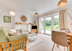 a living room with a couch and a table at Nyth Bryn Haul in Llanidloes