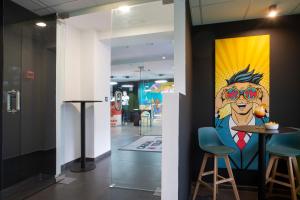 a painting of a man with glasses on a wall at Casual Pop Art Benidorm in Benidorm