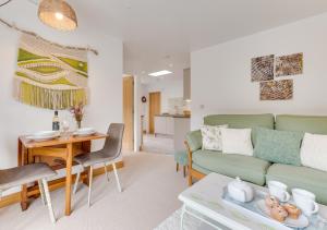 a living room with a couch and a table at Nyth Bryn Haul in Llanidloes