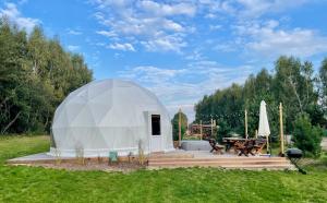 a large white dome tent in a field at beGLAMP - Glamping nad Zalewem Próba in Brzeźnio