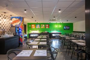 a restaurant with tables and chairs and green walls at Casual Pop Art Benidorm in Benidorm