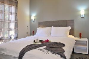 a bedroom with a bed with a blanket on it at Etnachta Kibbutz Afik in Afik +50 photos