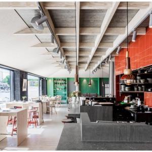 a restaurant with tables and chairs and green walls at Studio Living in Karlskrona