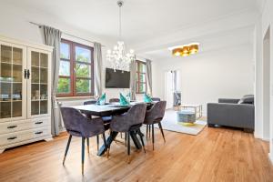 a dining room with a table and chairs at Residenz zu Montfort - Apartment Schlossblick in Tettnang