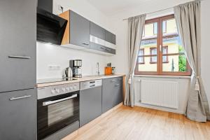 a kitchen with stainless steel appliances and a window at Schlossblick Tettnang in Tettnang
