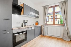 a kitchen with stainless steel appliances and a window at Residenz zu Montfort - Apartment Schlossblick in Tettnang