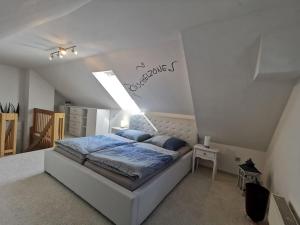 a bedroom with a bed in a white room at Ziemitz, Paradies am Peenestrom in Ziemitz