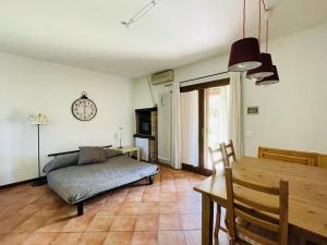 a bedroom with a bed and a table and a clock at Borgo del Nibbio in Porto Levante
