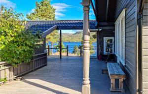 a porch with a bench and a view of a lake at Lovely Home In Fossdal With Kitchen in Fossdal