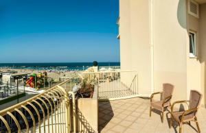 a balcony with chairs and a view of the beach at Hotel Beaurivage in Cattolica