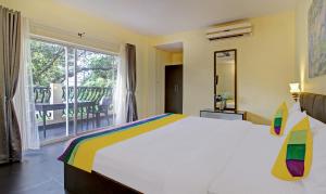 a bedroom with a large bed and a large window at Blue Door in Morjim