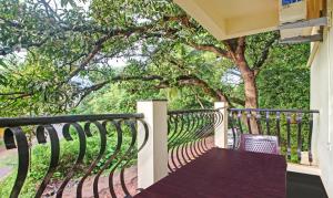 a porch with a wooden table and a fence at Blue Door in Morjim