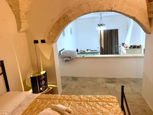 a bedroom with a bed in a room with a window at Lu Chiapparu - Vacanza Low Cost in Lequile