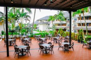 an empty patio with tables and chairs in front of a hotel at Villea Port Dickson in Port Dickson