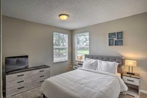a bedroom with a bed and a flat screen tv at Southern Dunes Golf Home Pool and Covered Patio in Haines City +25 photos