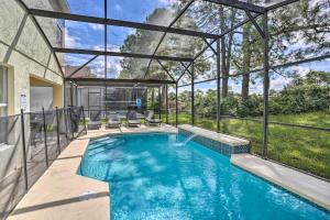 a swimming pool in a house with a glass ceiling at Southern Dunes Golf Home Pool and Covered Patio in Haines City