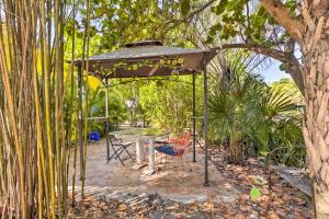 a gazebo with a table and a chair under it at Vibrant West Palm Beach Home Less Than 2 Mi to Beach! in West Palm Beach
