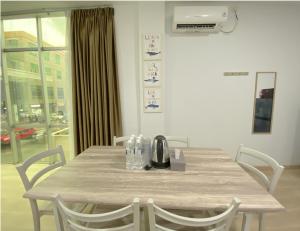 a dining room table with chairs and a table at CN Homestay A2 Floor 1 at Nagoya Hill Mall in Nagoya