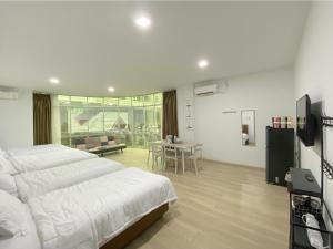 a large bedroom with two beds and a table at CN Homestay A2 Floor 1 at Nagoya Hill Mall in Nagoya