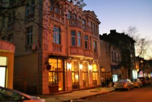 a large red building on the side of a street at Family Hotel Chiplakoff in Burgas
