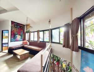 a living room with a bench and windows at Hostel Swastik in Bhaktapur