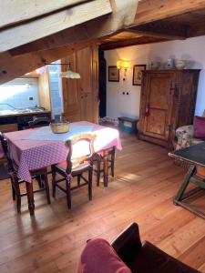 a dining room with a table and chairs in a room at Appartamento Laura in Madonna di Campiglio