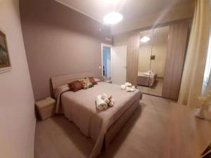 a bedroom with two stuffed animals on a bed at Nichila - Casa Vacanze acitrezza in Acitrezza