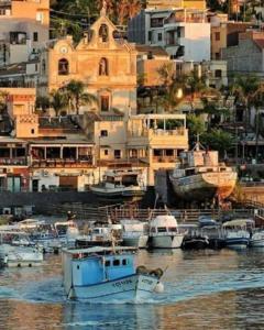 a group of boats are docked in a harbor at Nichila - Casa Vacanze acitrezza in Acitrezza