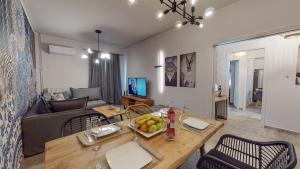 - un salon avec un canapé et une table avec des fruits dans l'établissement Motley Luxury Apartment by Estia, à Héraklion