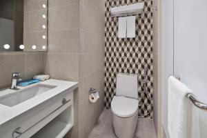 a bathroom with a toilet and a sink at Holiday Inn Express Singapore Serangoon, an IHG Hotel in Singapore