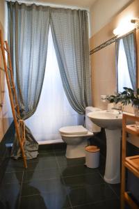 a bathroom with a toilet and a sink and a window at Lydia Boho House-Sea View, by Elefthia Syros in Megas Gialos - Nites +16 photos