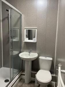 a bathroom with a toilet and a sink and a shower at Byelands House in Middlesbrough